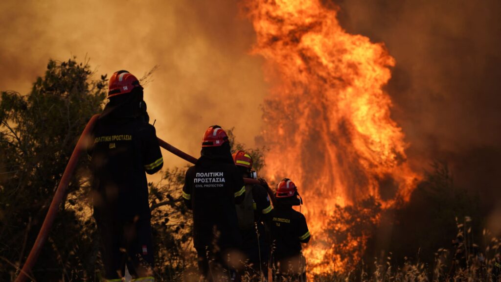 Pictures show firefighters battling raging wildfires in Greece
