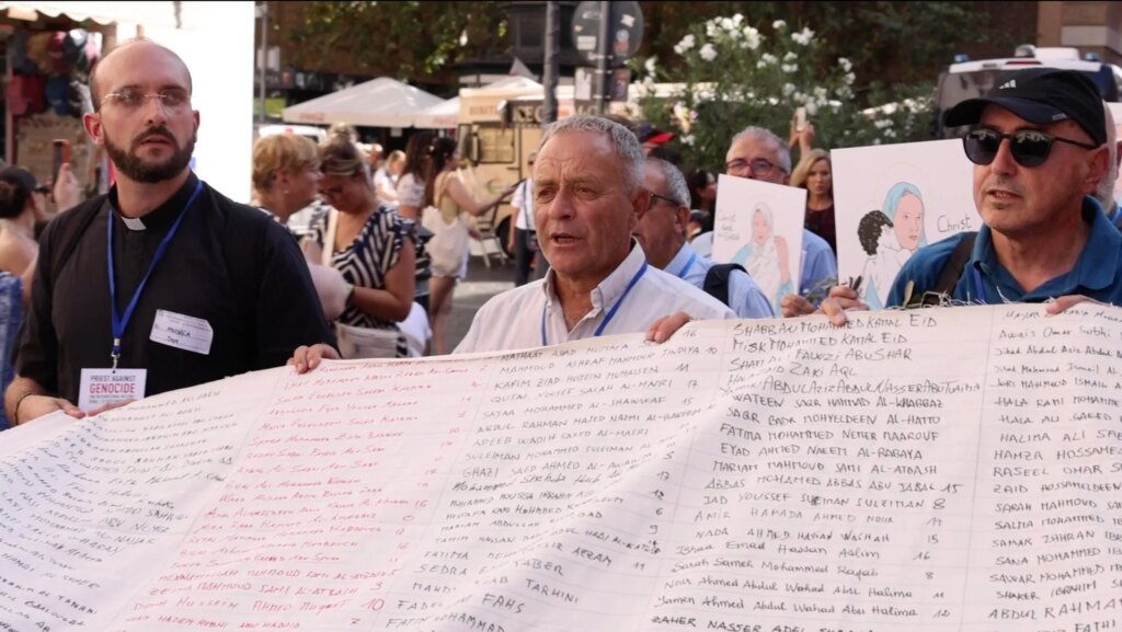 Priests Against Genocide hold shroud with names of children killed in Gaza | Israel-Palestine conflict